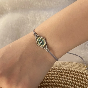 Bohemian hand-woven beaded bracelet with turquoise diamond pattern and adjustable cord