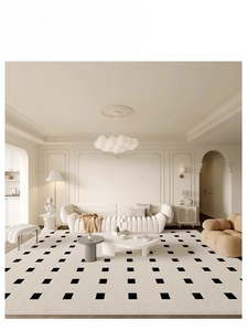 Detailed macro view of cream rug texture with black square patterns in a French style