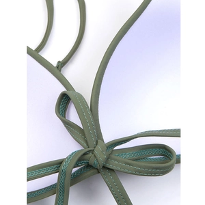 Detail of olive green bikini top featuring contrast stitching and soft white lining
