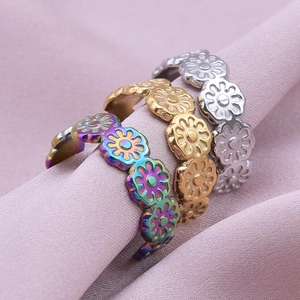 Three minimalist 304 stainless steel daisy flower rings in gold, silver, and rainbow tones