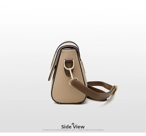 Detailed side profile of beige faux leather crossbody bag with brown trim and gold hardware