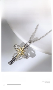 Detailed close-up of a silver cross pendant with a gold star and sparkling crystals