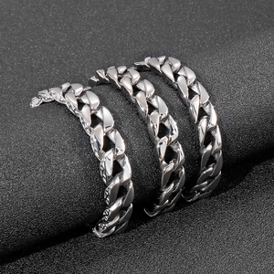 Detailed view of silver Cuban link bracelet with polished stainless steel on black display