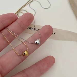 Minimalist titanium heart pendant necklace for women in polished gold and silver finishes