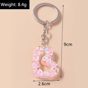 Pink resin alphabet B keychain with shell flakes showing 9cm length and 8.4g weight