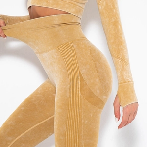 Detail of high-waist acid wash yoga pants showing elastic ribbing and tummy control