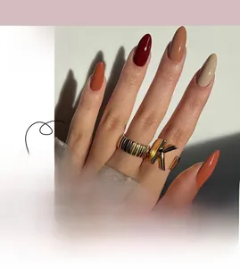 Detailed view of long almond press-on nails in burgundy, caramel, and cream shades