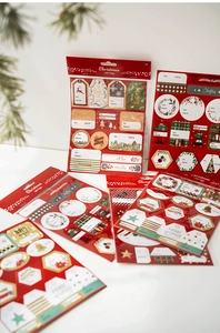 Close-up of festive Christmas gift tags in red and gold with Merry Xmas greetings
