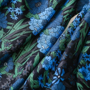 Detailed view of vintage navy blue floral print fabric with soft cotton-linen texture