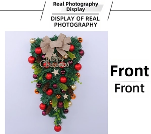 Detail of Christmas teardrop swag with gold balls, pine cones, and a burlap bow decoration