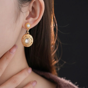 Vintage gold drop earrings with white pearls and sparkling crystals in baroque style