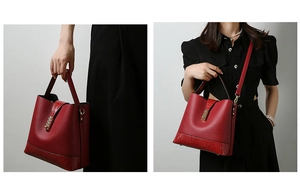Detail of red textured leather tote with gold hardware and removable shoulder strap