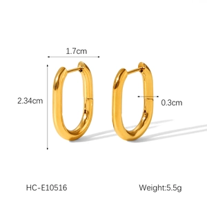 Detail view of gold-plated oval hoop earrings with exact dimensions 2.34cm by 1.7cm