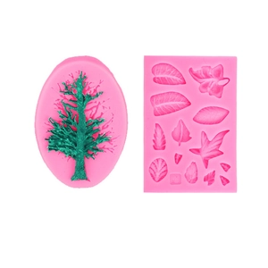 Pink silicone tree and leaf shaped fondant molds for DIY cake decorating on white background