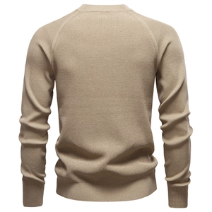 Detail view of khaki knit sweater back featuring ribbed cuffs and a round neckline