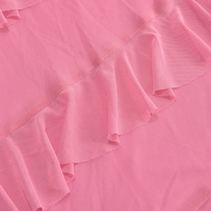 Detailed view of pink mesh fabric layers with delicate ruffled edges for summer dress