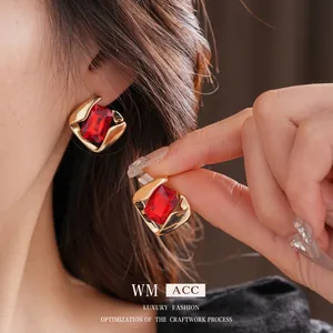 Elegant gold square stud earrings with faceted red gemstone for a vintage luxury look
