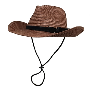 Detail of the woven straw cowboy hat with a black decorative band and metal buckle