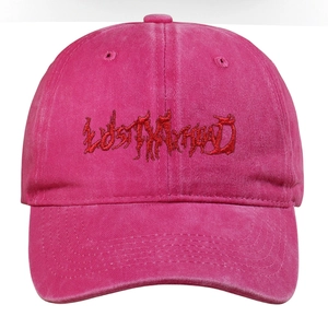 Detailed close-up of gothic embroidery on rose pink washed cotton baseball cap