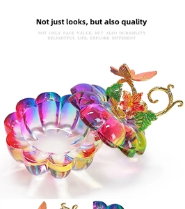 Detail of gradient glass nail art cup with decorative floral enamel butterfly lid