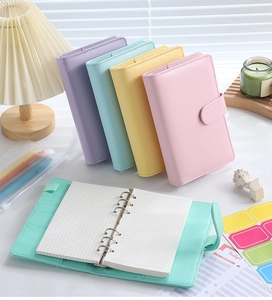 Detail of A6 PU leather macaron binder showing inner 6-ring mechanism and paper