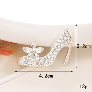 Macro detail of rhinestone high heel brooch showing 3.2cm height and 4.2cm length dimensions