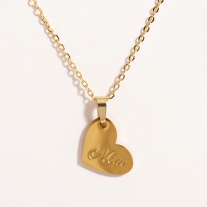 Macro view of gold titanium heart necklace pendant featuring Mom engraving and O-chain detail