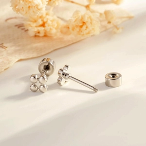 Minimalist silver clover flower cartilage earrings with screw back ball closure