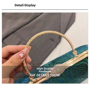 Detail of green brocade embroidery with gold floral ring handle and vintage metal clasp