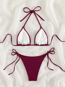 Detailed flat lay of burgundy ribbed fabric bikini with halter top and side tie bottoms