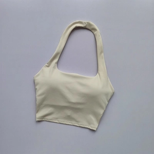 Detail of cream halter yoga sports bra showing flat neckline and seamless stitching