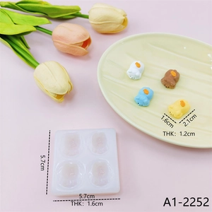 Detailed size view of a 4-cavity mini bear silicone mold with colorful resin finished products