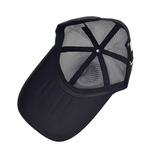 Detail view of polyester mesh trucker hat interior with clean stitching and care label