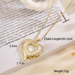 Detail of MOM heart pendant necklace with shell inlay and crystals on an open book