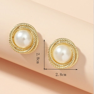 Detail view of 2.8cm golden rope-twist earrings with inlaid baroque white pearls