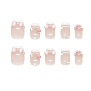 French press-on nails with pink gradient base, pearl accents, and sparkling rhinestones