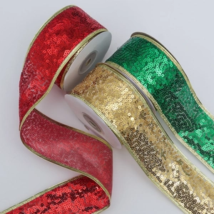 Close-up of sparkling sequin ribbons in red green and gold for festive gift wrapping