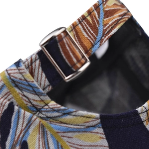 Detail of adjustable metal buckle and colorful leaf pattern on the back of baseball cap