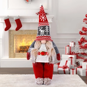 Standing Nordic faceless Christmas gnome doll with snowflake hat by the fireplace