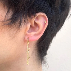 Gold LOVE letter earrings with rhinestone teardrop stud on model for modern women