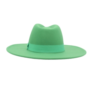 Detail of elegant emerald green wool fedora hat featuring matching decorative ribbon band
