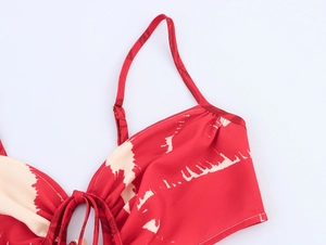 Detail of red and cream tie-dye dress with adjustable thin straps and drawstring front