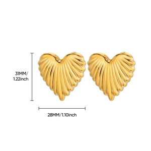 Macro view of gold heart earrings showing ridged texture and dimensions of 31mm by 28mm