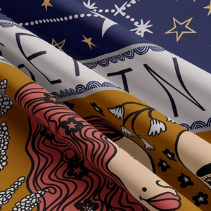 Detail of artistic zodiac tapestry fabric with celestial stars and moon illustrations