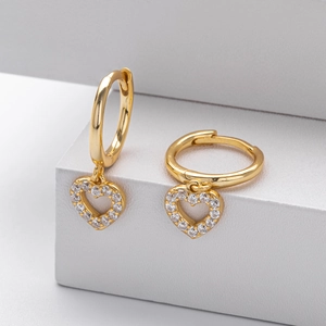 Detail of s925 silver heart hoop earrings with micro-inlaid stones on white podium