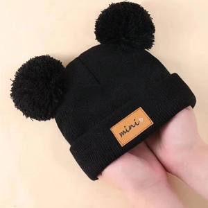 Kids black knit beanie with double faux fur pom-poms and leather logo patch