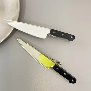 Funny miniature kitchen knife hair clips set in silver and black on grey background