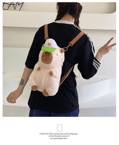 Detail view of a plush capybara backpack with a sun hat on a model's back