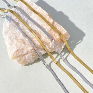 Minimalist flat snake chain bracelets in gold and silver finish on elegant stone base