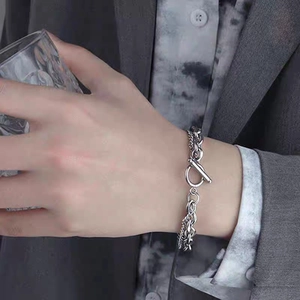 Silver double-layer chain bracelet with OT toggle clasp worn by model for hip-hop style